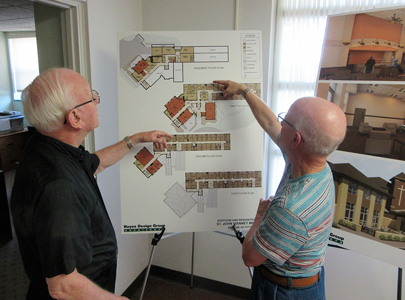 Auxiliary Bishop William Winter and Father Philip Przybyla review architectural plans for the renovation and expansion of St. John Vianney Manor. Photo Credit : Bob Dewitt